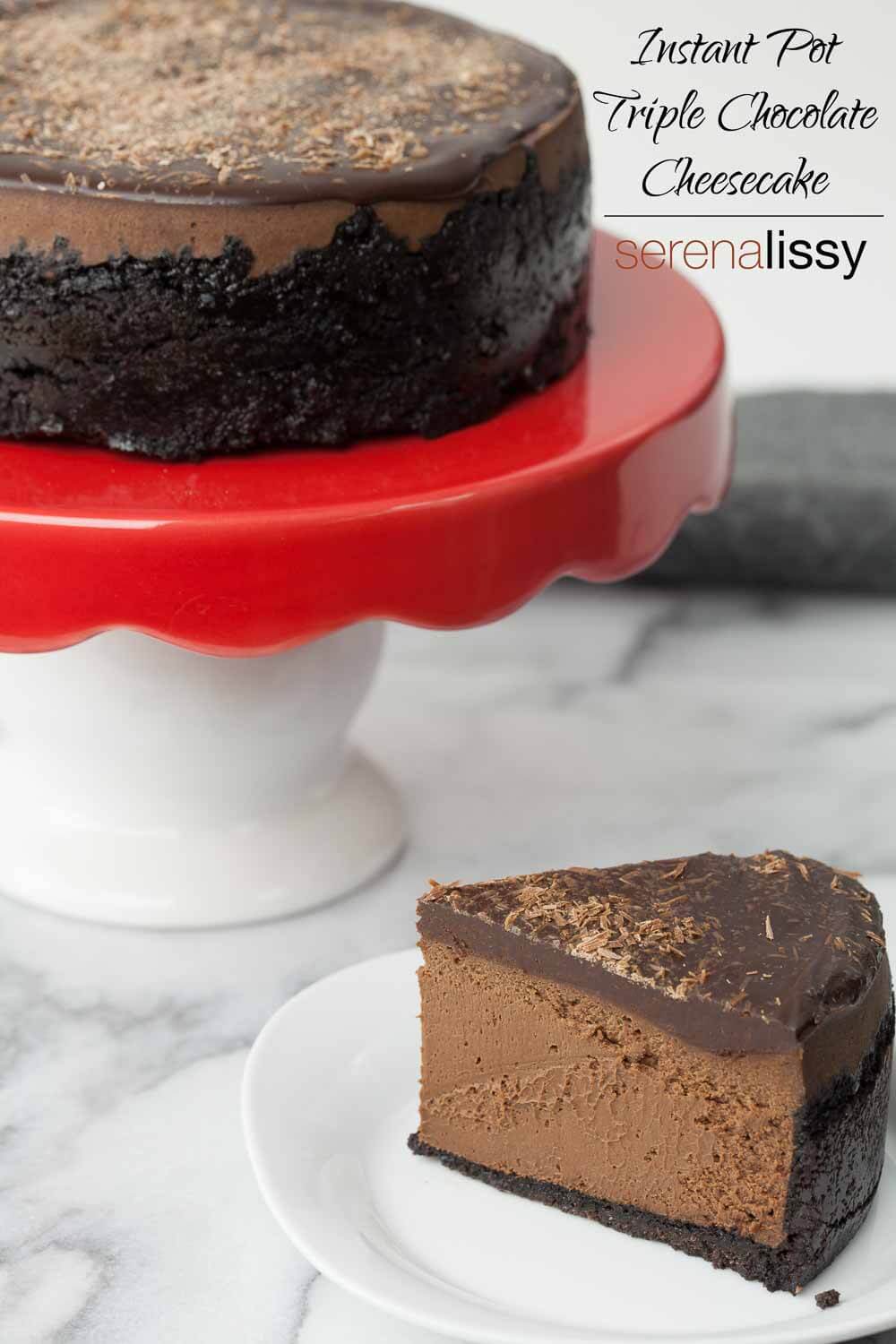 Slice of Instant Pot Triple Chocolate Cheesecake topped with Chocolate Ganache on a plate beside a whole instant pot cheesecake. 
