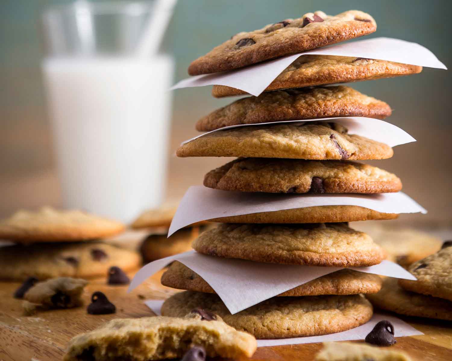 Stack of cookies with glass of milk in background