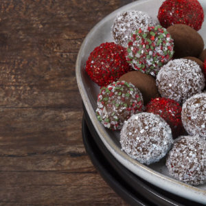 Baileys Truffles on a white deep dish on a wooden surface