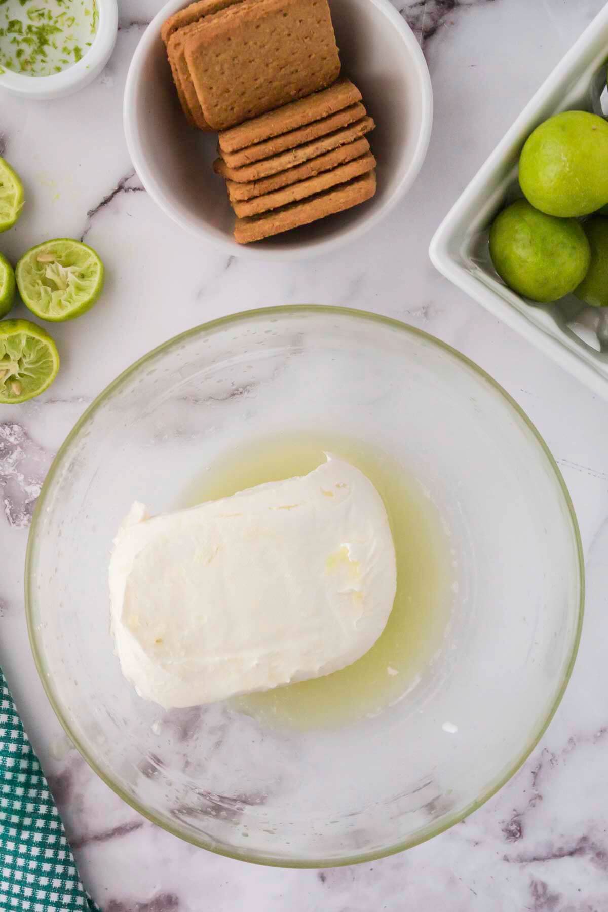 Whip cream cheese and key lime juice in a bowl